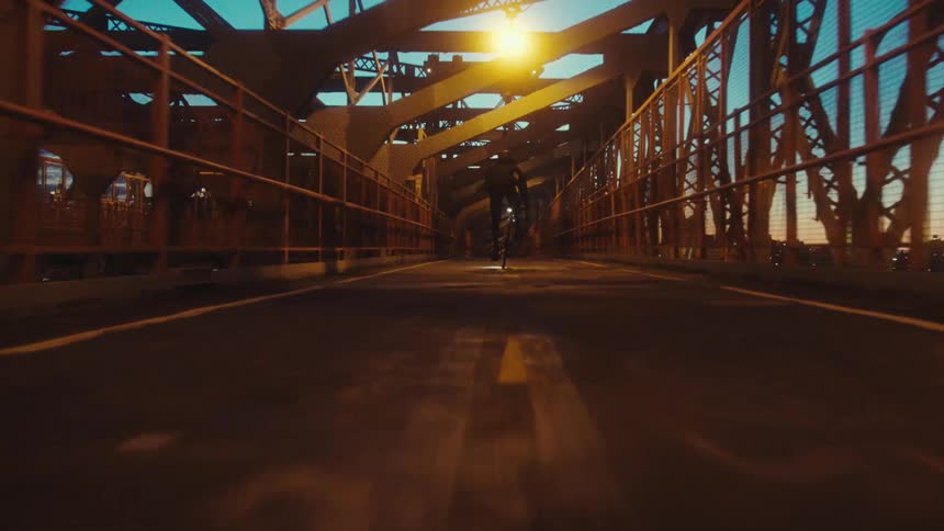 Riding a bicycle on a city bridge