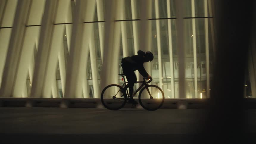 A man is riding his bicycle in the city