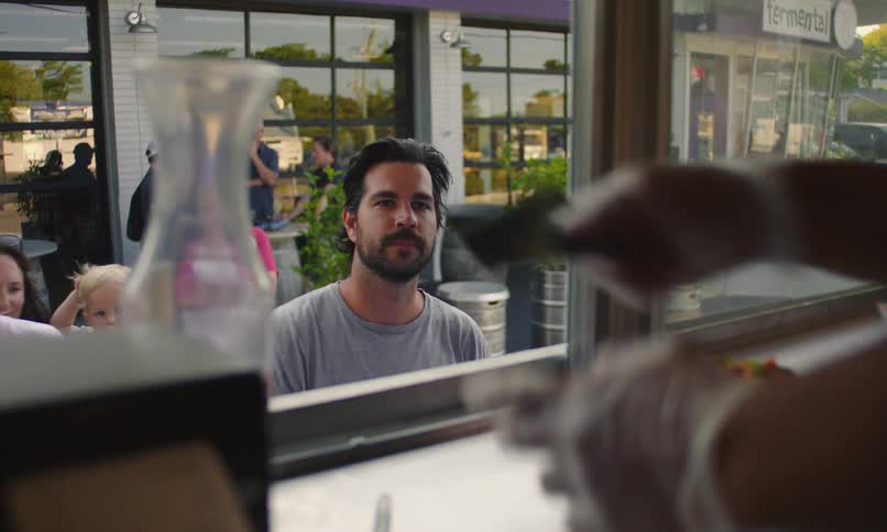 Man handing a card to a waiter at a food truck