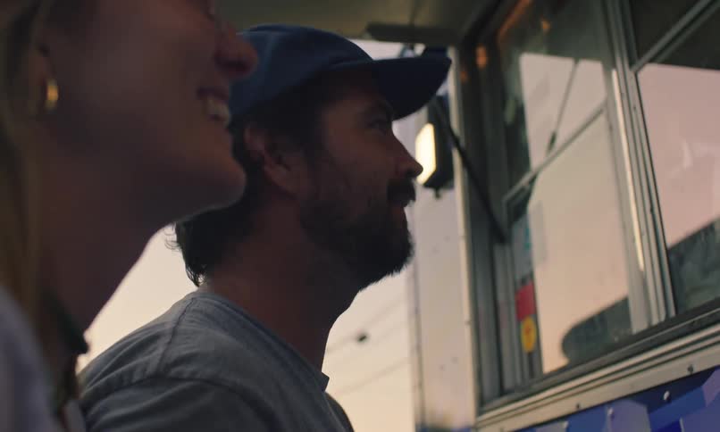 A man and woman order from a food truck
