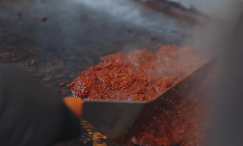Cooking surface with meat being prepared