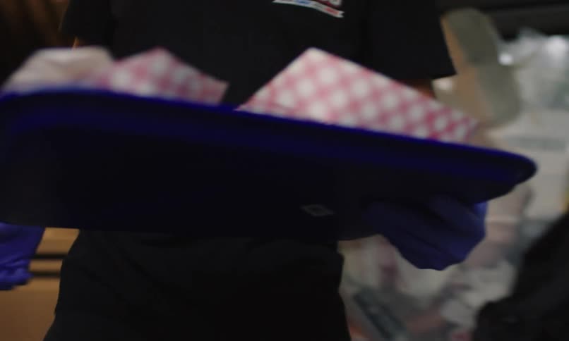 Man carrying a tray with snacks