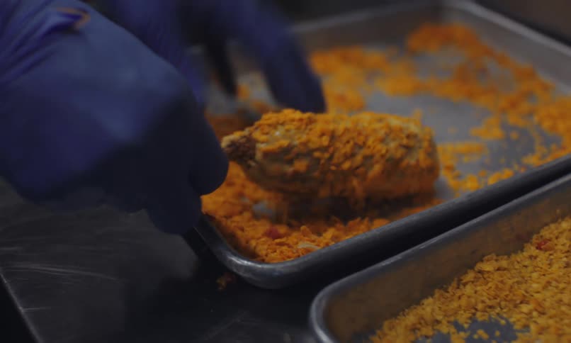 A person is making corn dogs in the food truck