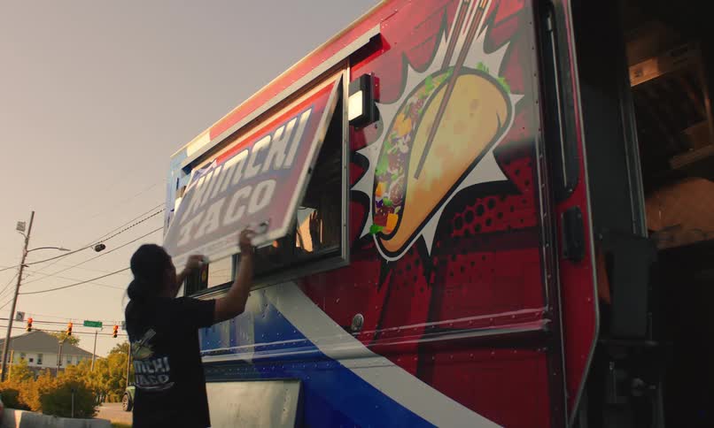 Man opening the window door of his mexican taco food truck