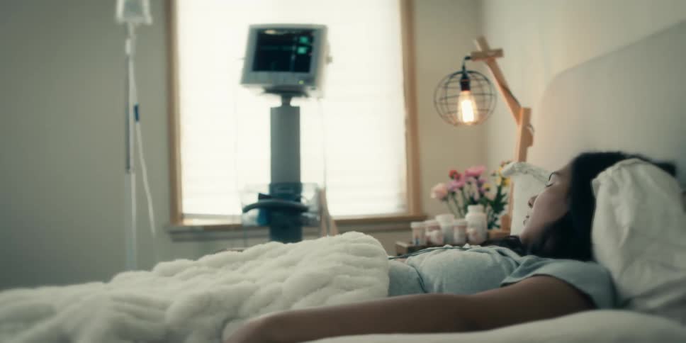 A woman is resting while attached to a monitor