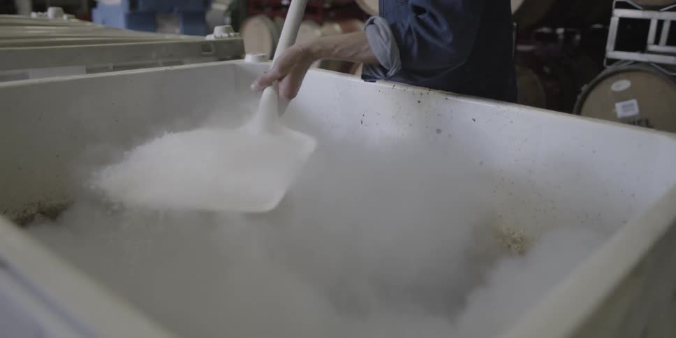 Someone is shoveling dry ice into a box