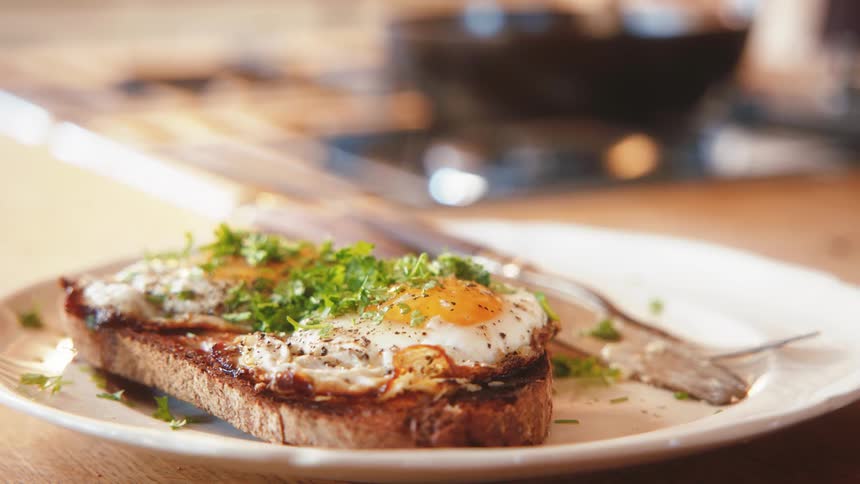 A plate with eggs on a toast