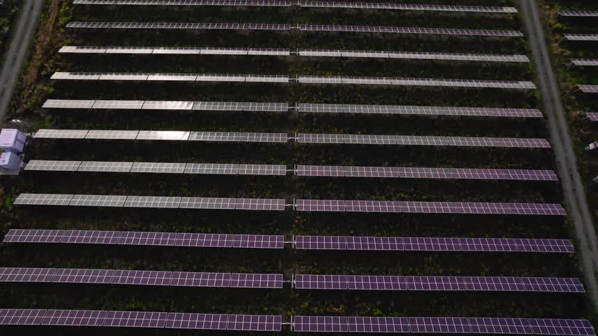 Aerial view of solar panels in a vast field