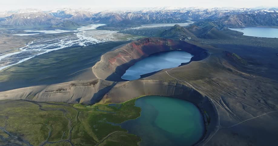 Aerial of several lakes in front of a mountain range