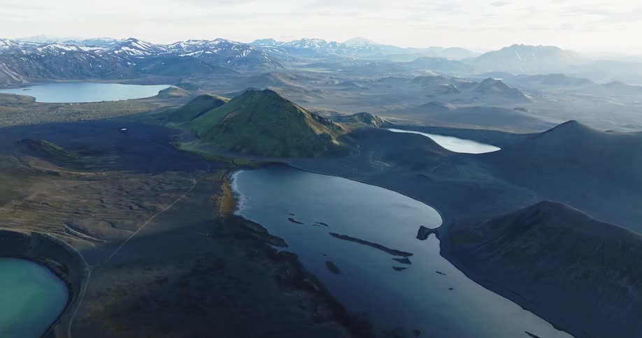 A mountain range with volcanic craters and lakes