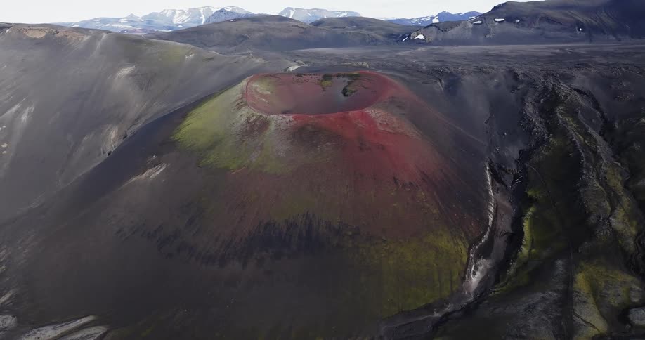 An aerial view of a mountain with a huge crater on top