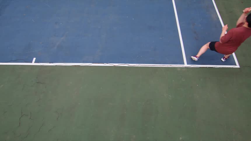 Man throwing a racket on a tennis court