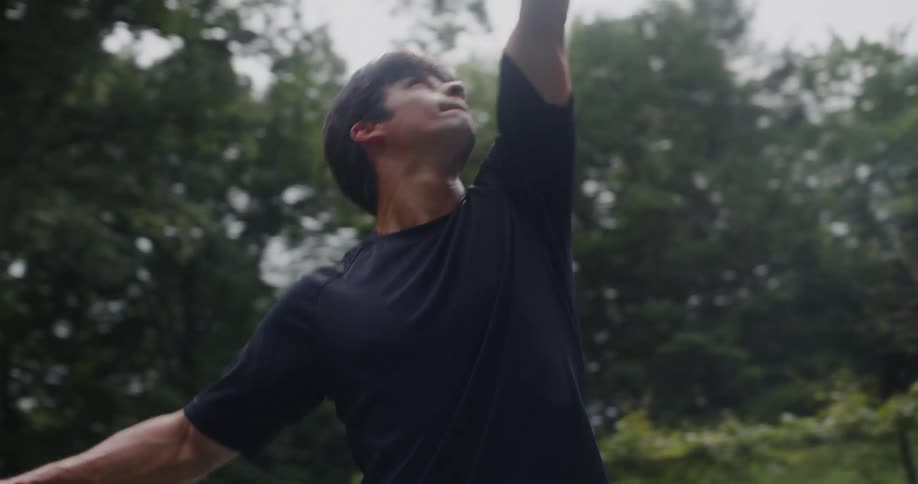 Teenage boy serves a tennis ball to another teenage boy