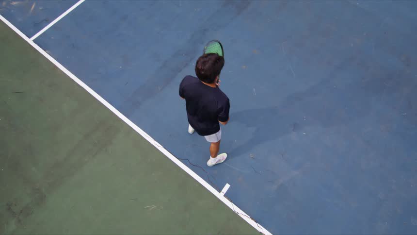 Young man playing tennis on a court