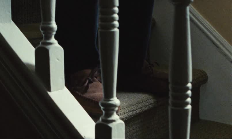 Elderly person's feet descending stairs