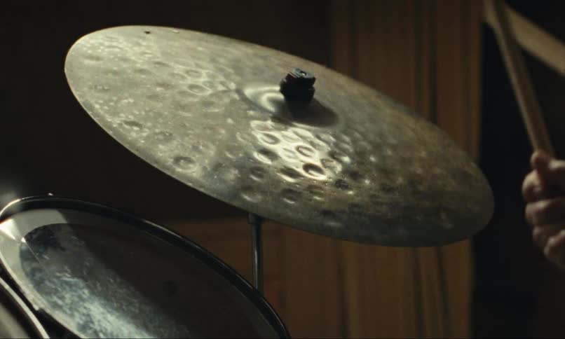 A drummer plays a ride cymbal