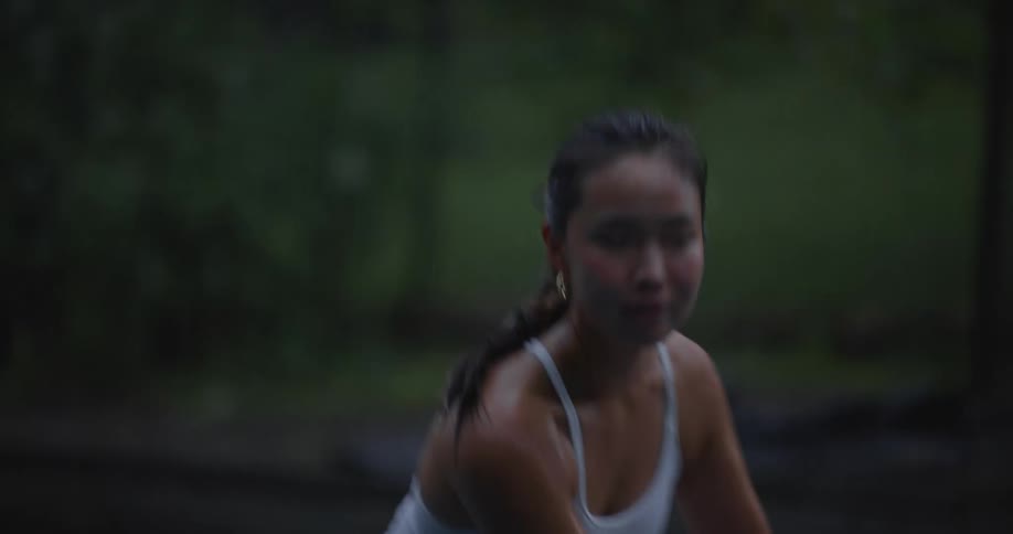 Asian woman concentrated playing tennis
