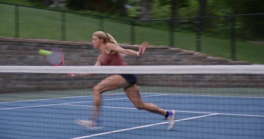 Woman on an open court playing tennis