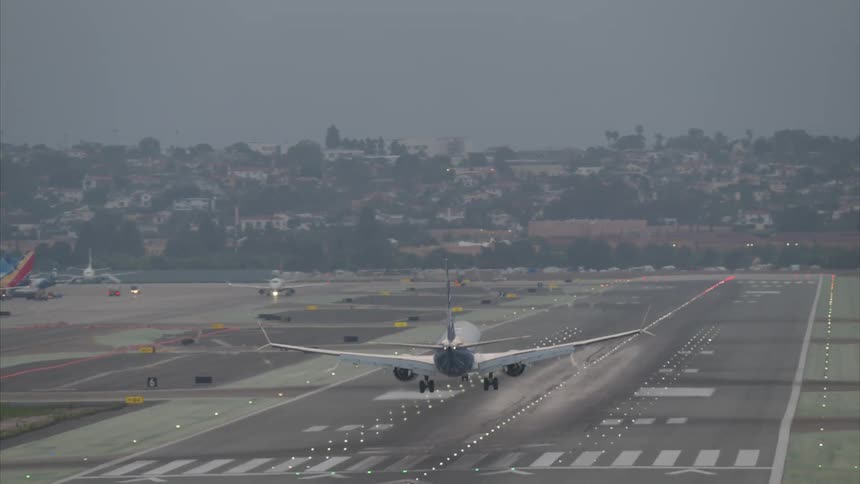 An airplane lands at the airport runway