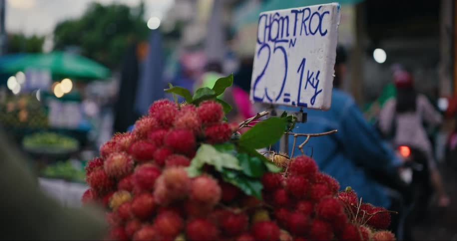 Red fruit for sale on a city street food stand