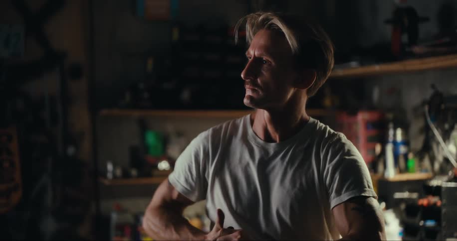 Portrait of a man inside a garage with tools