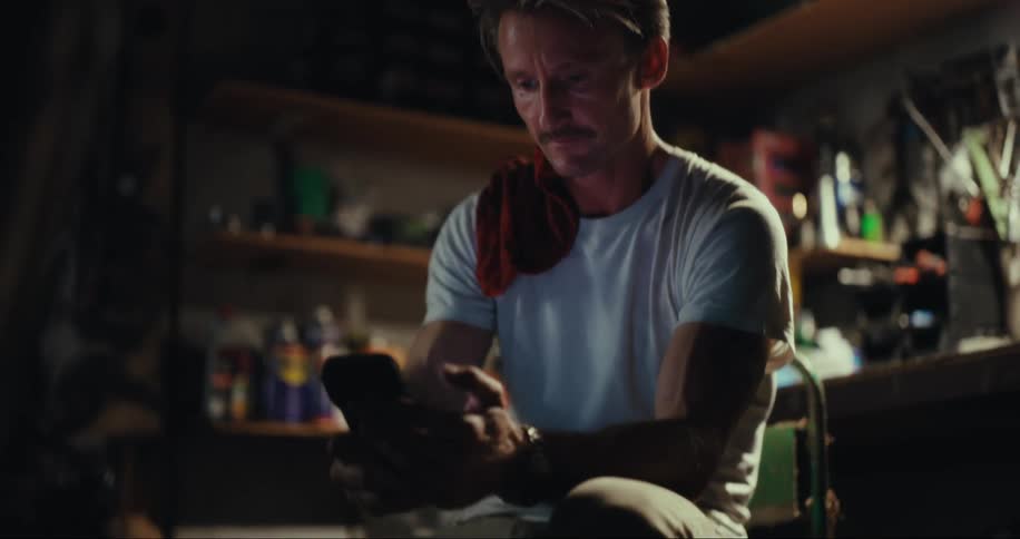 Man sitting in a chair using his cell phone