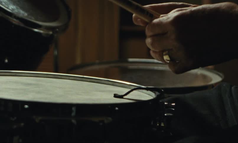 Picking up a pair of drumsticks