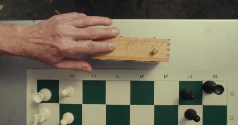 Two people playing a game of chess with a time clock