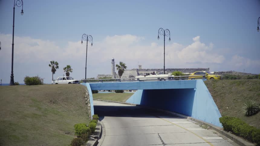 Cars cross an overpass on a sunny day