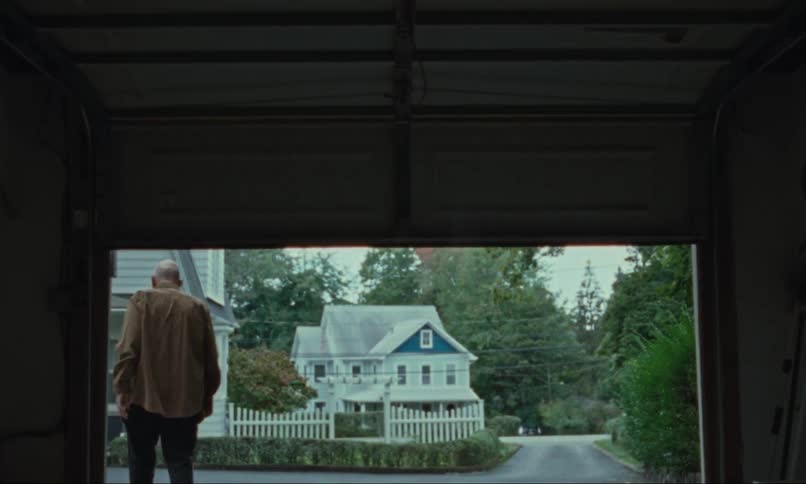 Elderly man leaving and closing it a garage
