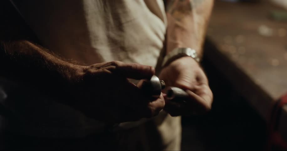 Pair of hands adjusting a tool in a mechanics