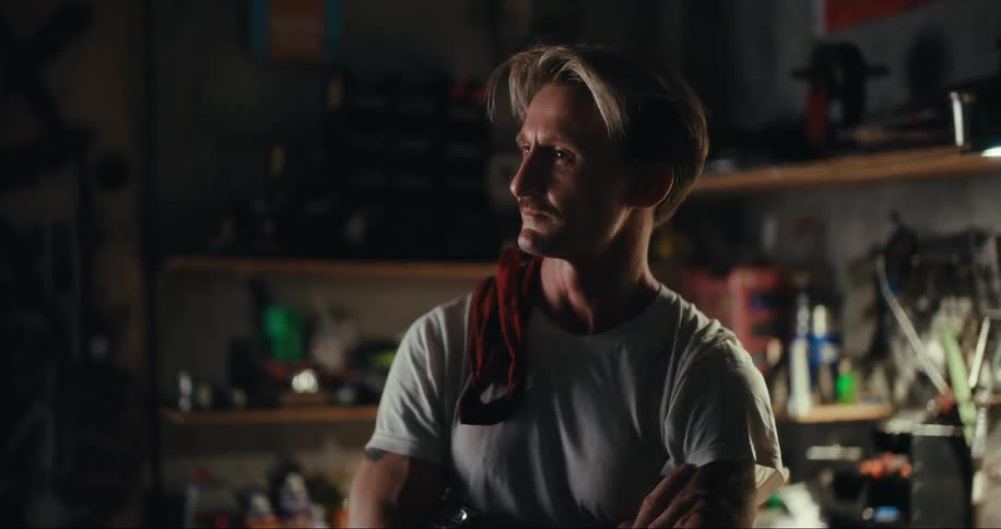 Portrait of a man in a garage with workshop equipment