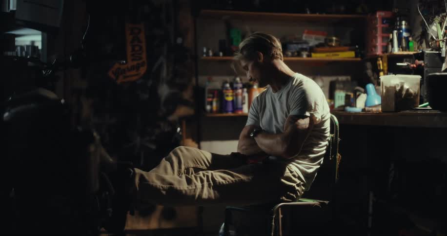 Portrait of a man sitting in a workshop drinking water