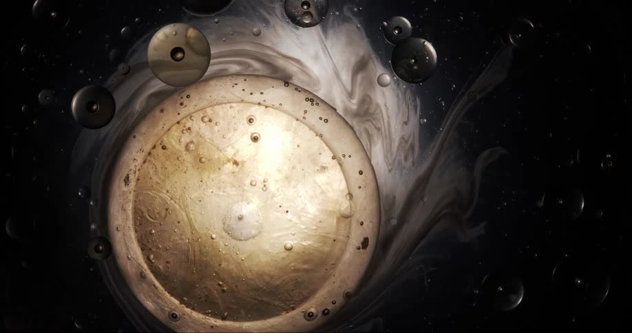 Composition of a moving liquid with bubbles and a shiny surface in the center