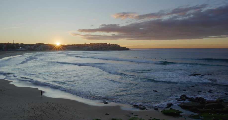 Landscape of a beach and a person alone on the sand at dawn