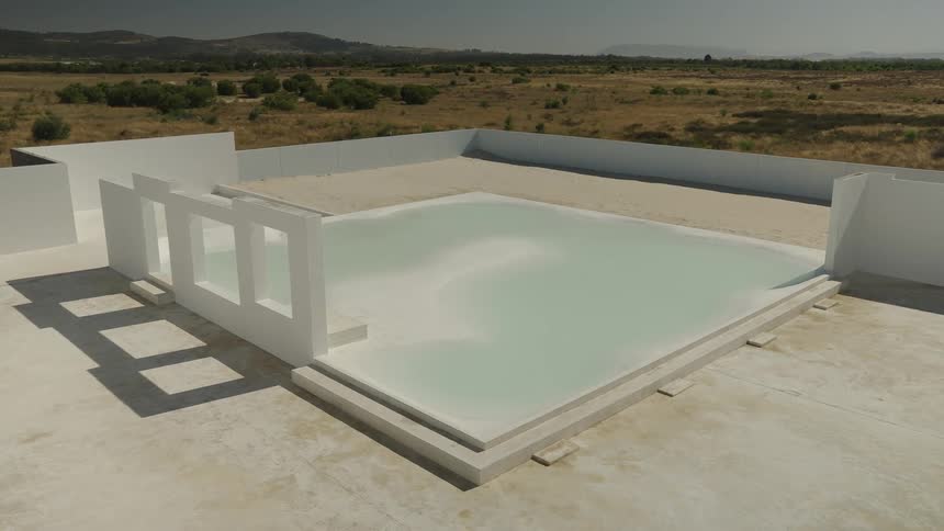 A foundation of a white building with a huge white square on the floor