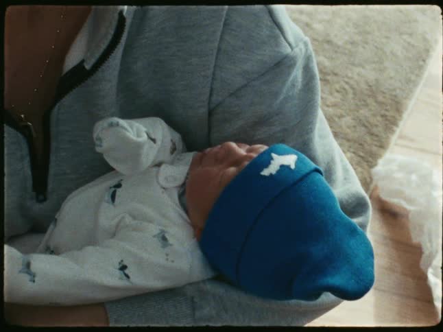 Happy mother holding her newborn baby