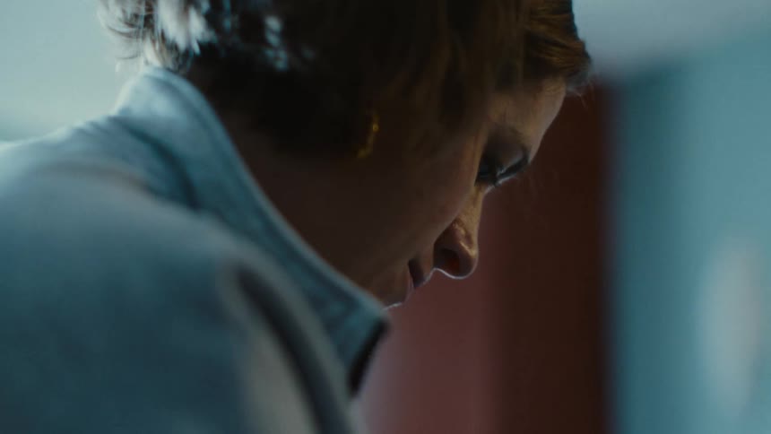Woman focusing on whats in her hands with a determined look on her face