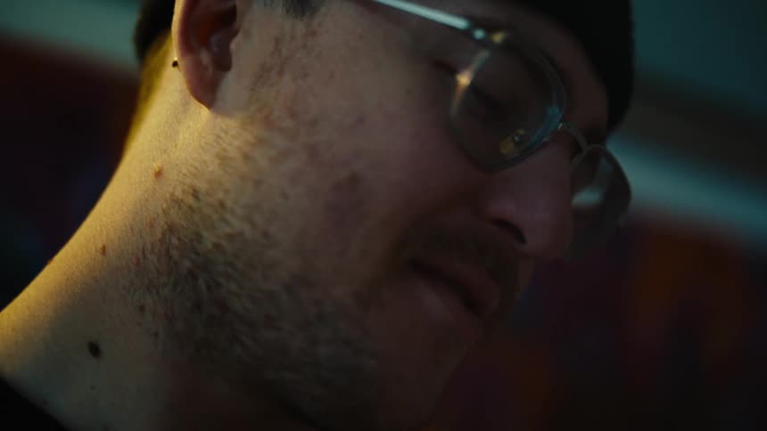Portrait of a man with a beard and glasses in an indoor setting