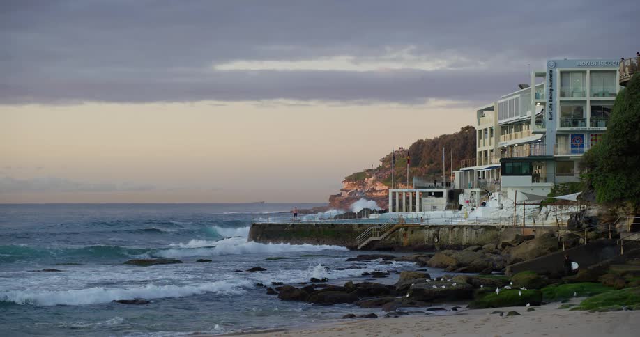 A beachfront resort with big waves crashing onto the shore