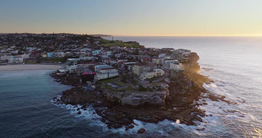 Aerial panorama of a coastal town surrounded by the sea view at sunrise