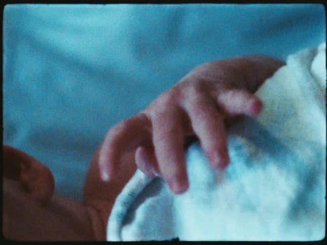A closeup of a newborn babys hand moving