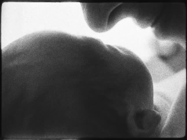 Mothers face close to her newborn baby