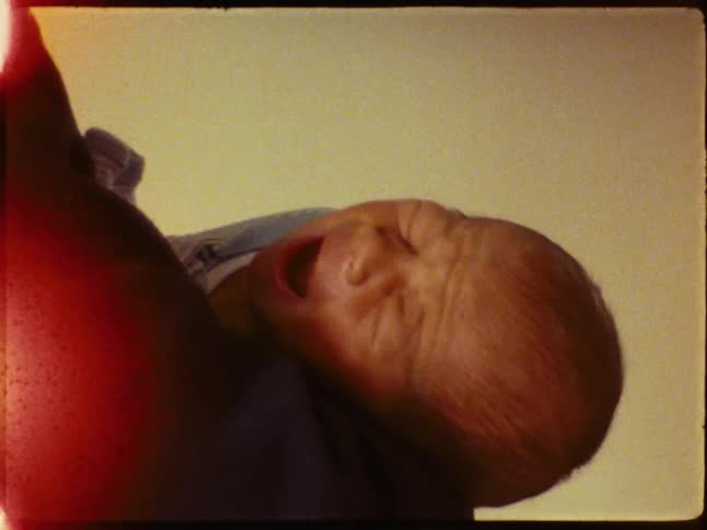 Person holding a newborn baby on their lap