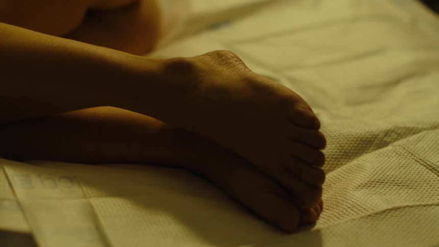 Closeup of a womans feet together lying down
