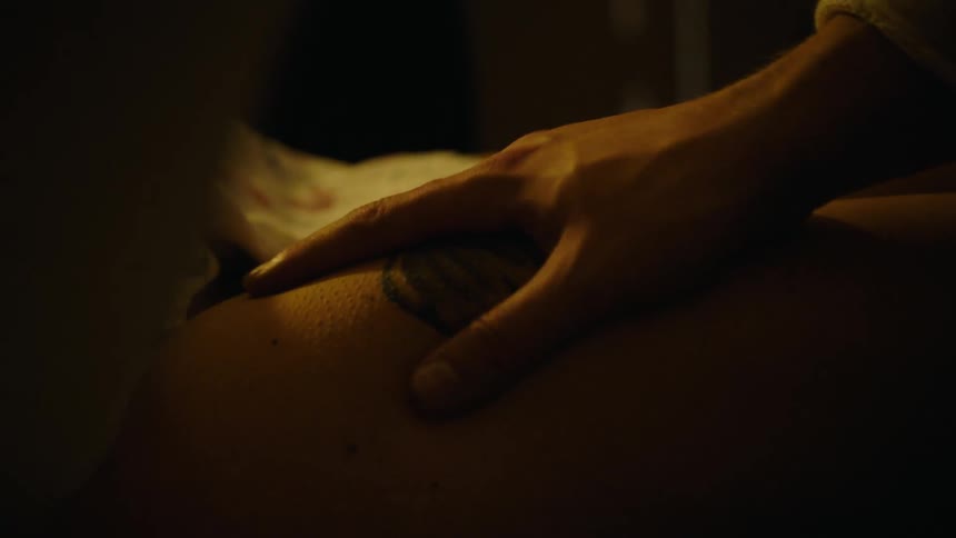 Hand massaging the belly of a pregnant woman with contractions