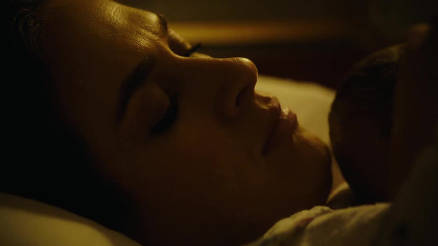 Portrait of a mother woman lying with a newborn baby on her chest