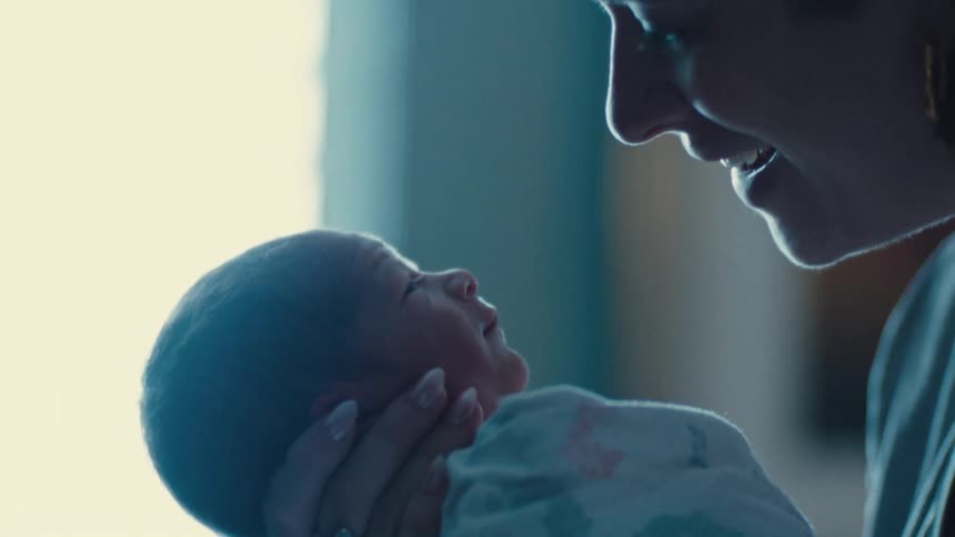Smiling mother with her newborn baby