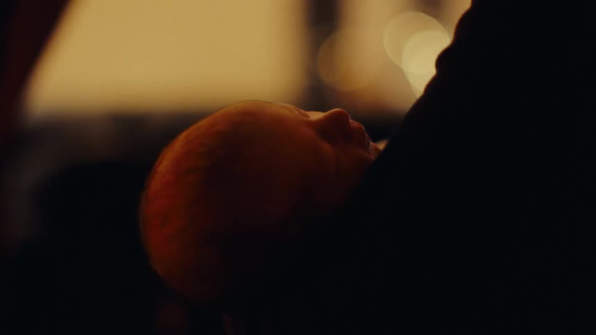 A mother tenderly holding her baby in her arms