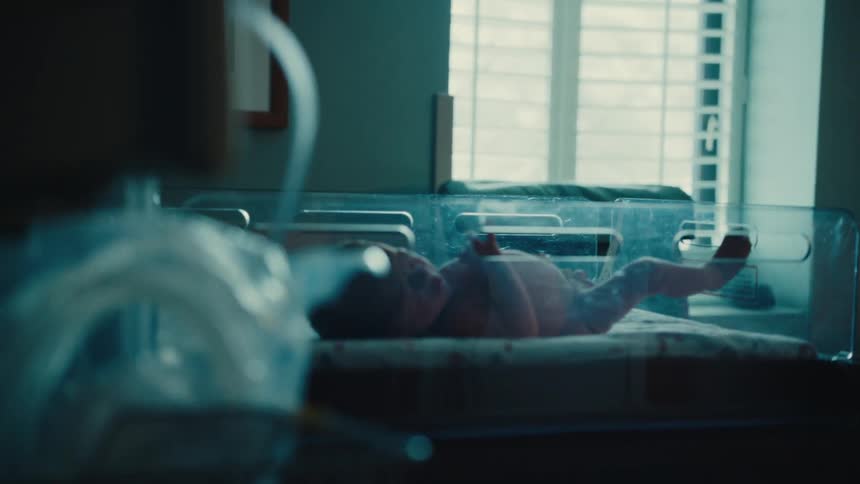 A baby kicks in its bed